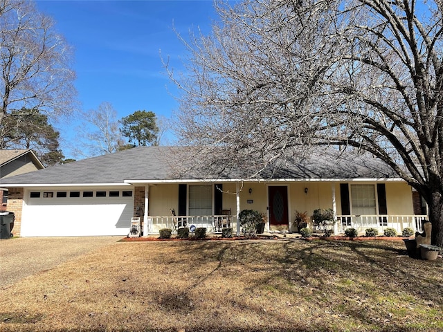 view of front of home with a garage, covered porch, and a front yard