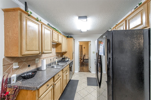 kitchen featuring sink, tasteful backsplash, black appliances, a textured ceiling, and light tile patterned flooring