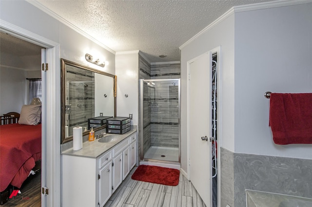 bathroom featuring walk in shower, ornamental molding, a textured ceiling, and vanity