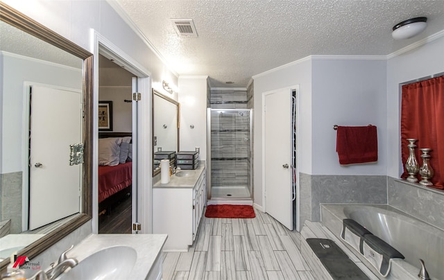 bathroom featuring ornamental molding, vanity, plus walk in shower, and a textured ceiling