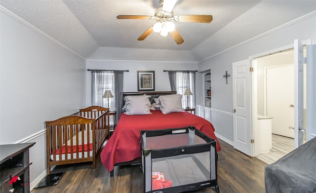 bedroom featuring multiple windows, ornamental molding, dark hardwood / wood-style floors, and a textured ceiling