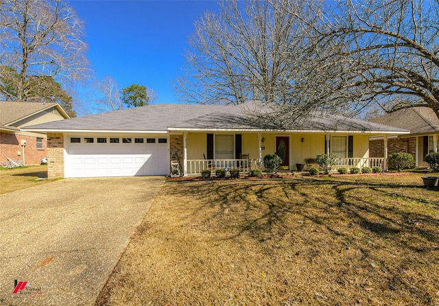 ranch-style home with a garage, a front yard, and covered porch