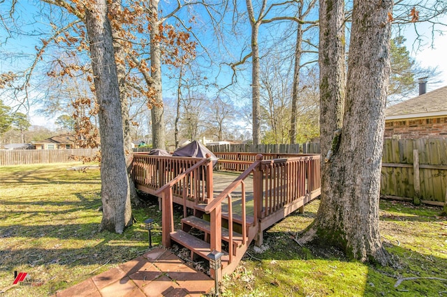 wooden deck featuring a yard