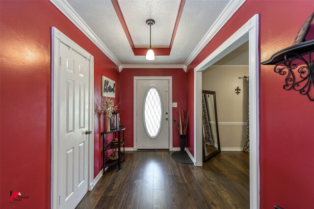 foyer featuring dark hardwood / wood-style flooring, crown molding, and a textured ceiling