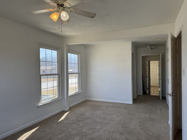 carpeted empty room featuring ceiling fan