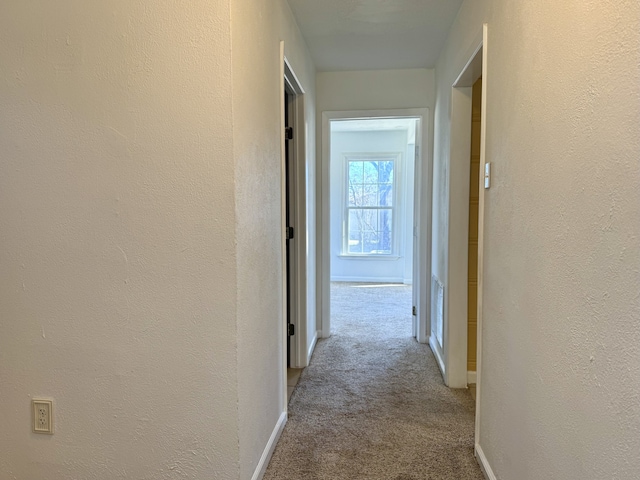 hallway featuring light carpet