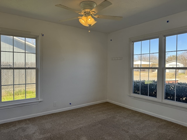 carpeted spare room with ceiling fan