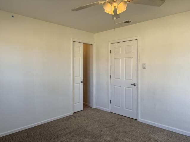 unfurnished bedroom featuring dark wood-type flooring and ceiling fan