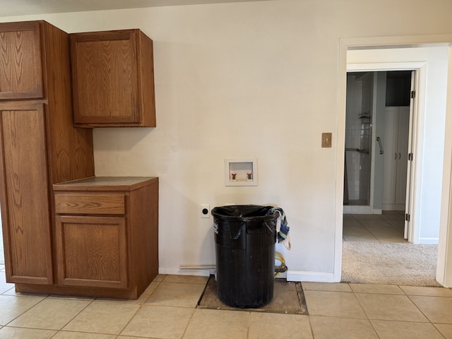 interior space with electric dryer hookup, washer hookup, and light carpet