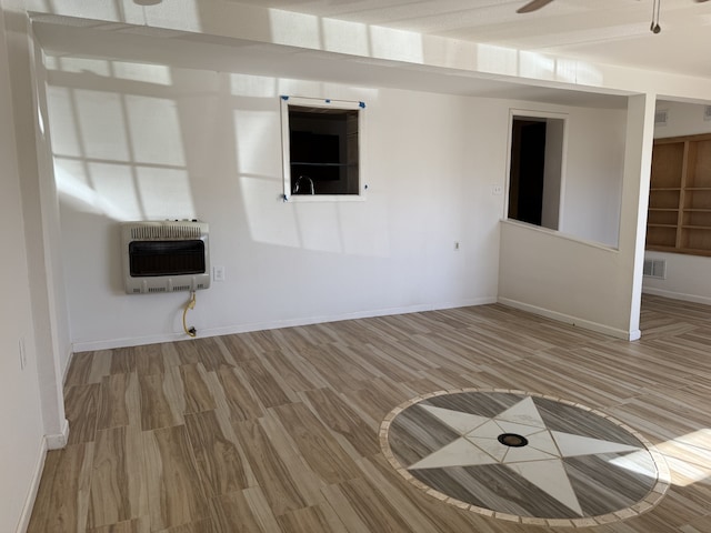 interior space featuring heating unit and hardwood / wood-style flooring