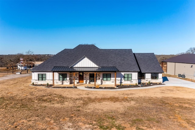 modern farmhouse style home with a front lawn