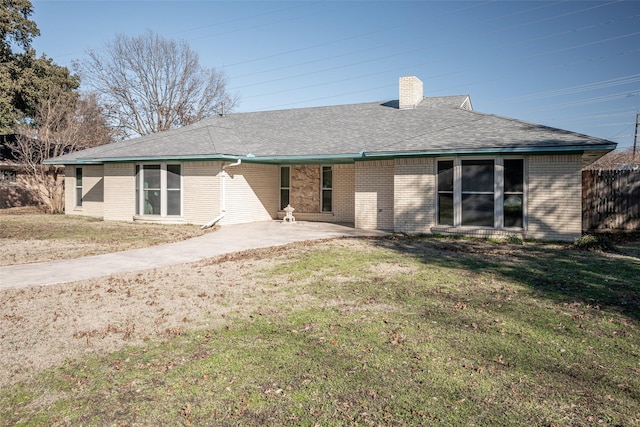 rear view of house featuring a patio area and a lawn