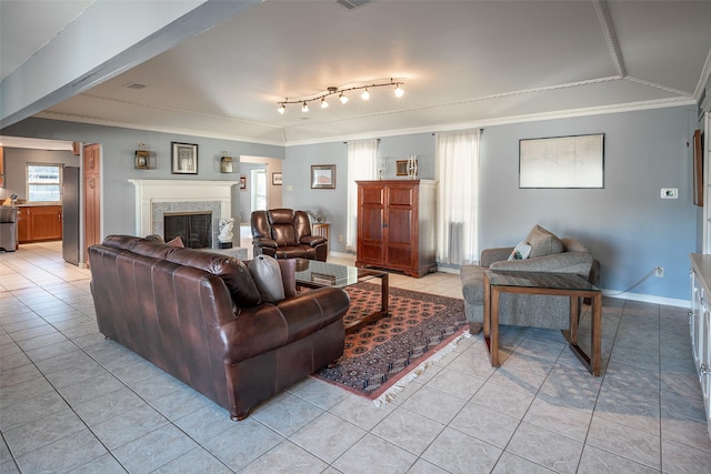 living room with crown molding, rail lighting, and light tile patterned floors