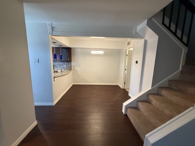 hallway featuring dark hardwood / wood-style flooring