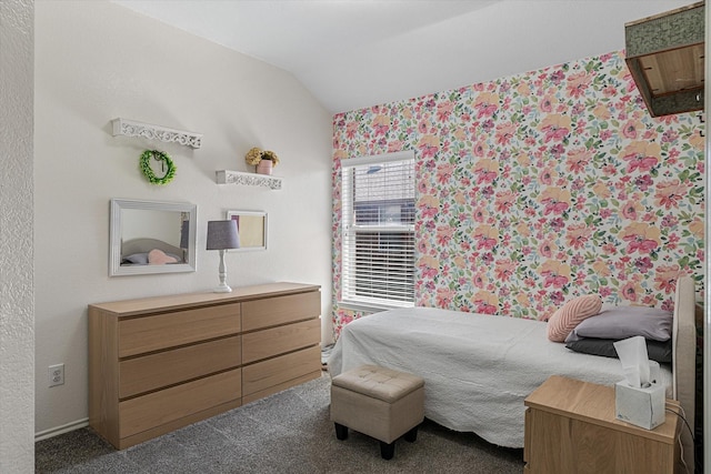 bedroom featuring lofted ceiling and dark colored carpet