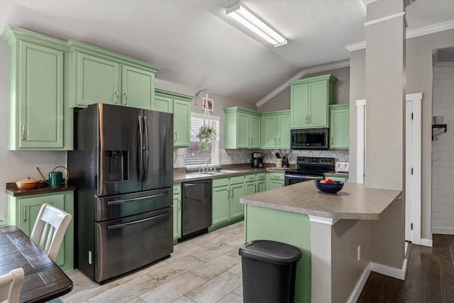 kitchen featuring ornate columns, appliances with stainless steel finishes, tasteful backsplash, lofted ceiling, and green cabinetry