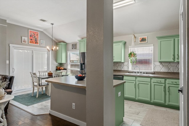 kitchen with lofted ceiling, sink, tasteful backsplash, a wealth of natural light, and pendant lighting