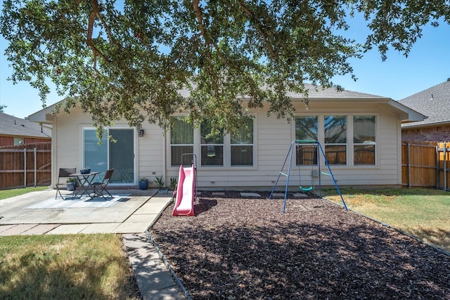 back of house featuring a yard and a patio area