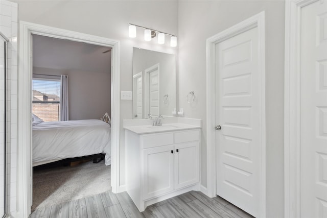 bathroom featuring wood-type flooring, vanity, and walk in shower