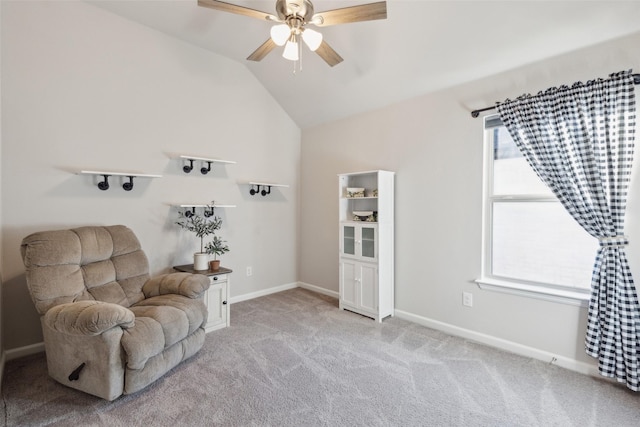 sitting room with ceiling fan, light colored carpet, vaulted ceiling, and a wealth of natural light