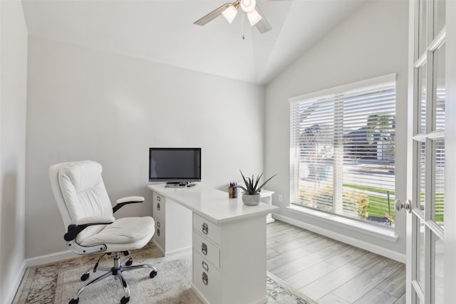 office space featuring french doors, ceiling fan, lofted ceiling, and light wood-type flooring