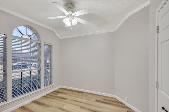 spare room with ceiling fan, ornamental molding, light hardwood / wood-style floors, a textured ceiling, and vaulted ceiling