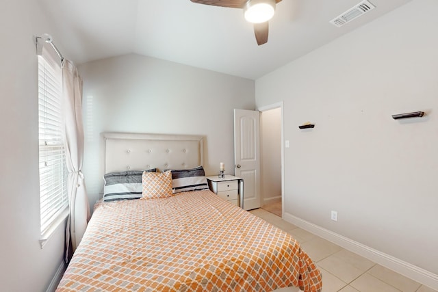 bedroom with vaulted ceiling, ceiling fan, and light tile patterned flooring