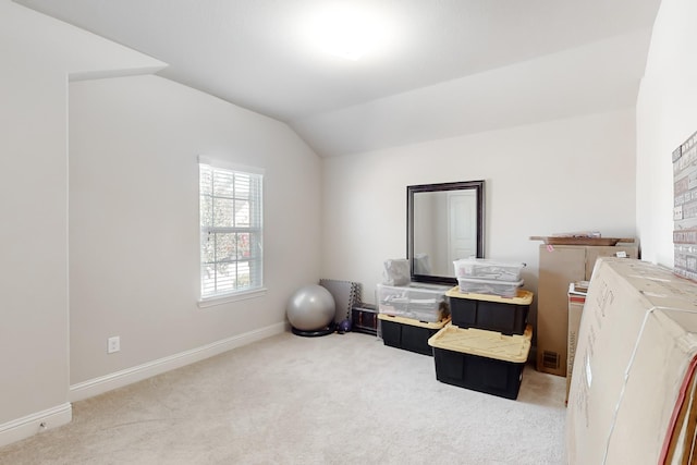 miscellaneous room with vaulted ceiling and carpet