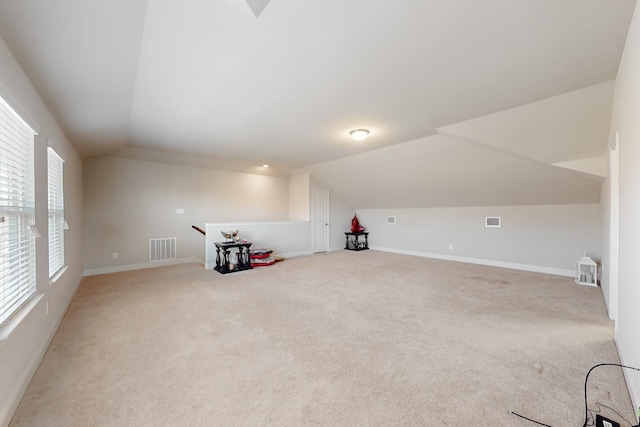 bonus room featuring lofted ceiling and carpet