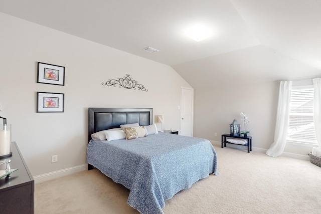 carpeted bedroom featuring lofted ceiling