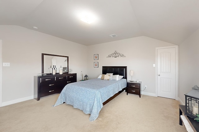 carpeted bedroom with lofted ceiling