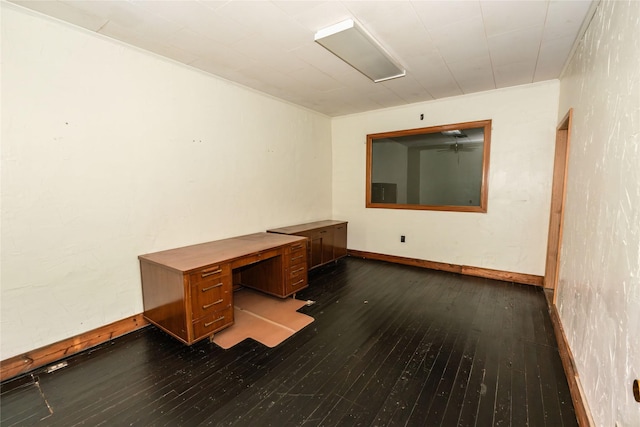 unfurnished office with wood-type flooring and crown molding