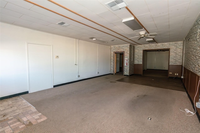 basement featuring ceiling fan and carpet