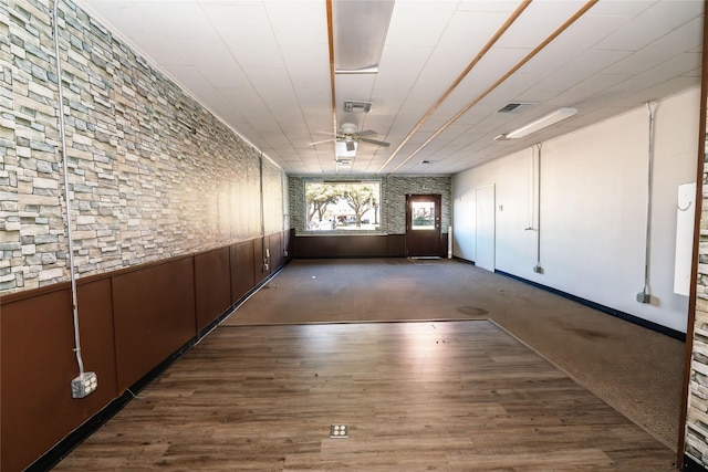 interior space with ceiling fan and dark colored carpet