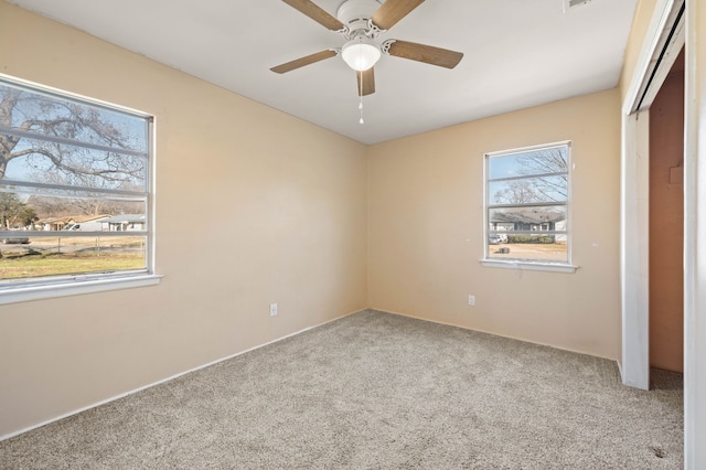 unfurnished bedroom featuring light colored carpet, a closet, and ceiling fan