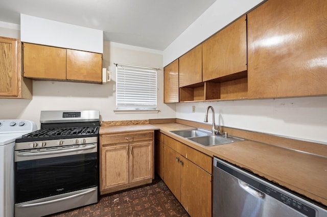 kitchen featuring appliances with stainless steel finishes, washer / dryer, and sink