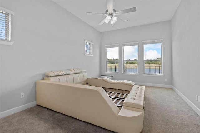 bedroom featuring a water view, carpet floors, and ceiling fan