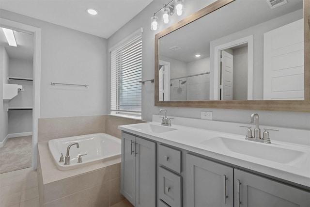 bathroom with vanity, a wealth of natural light, tile patterned floors, and shower with separate bathtub