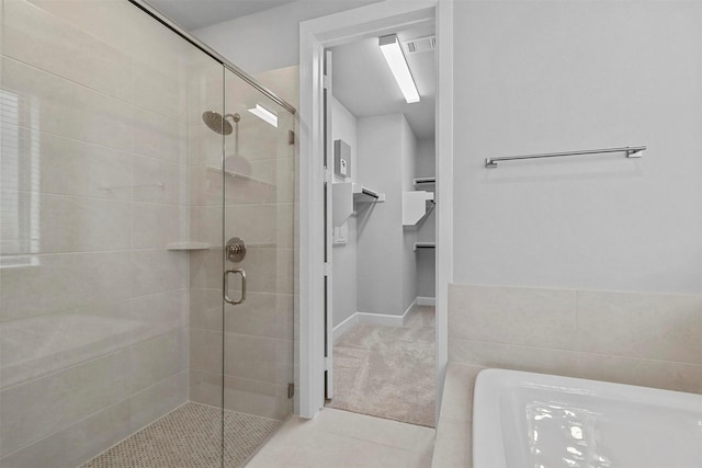 bathroom featuring an enclosed shower and tile patterned flooring