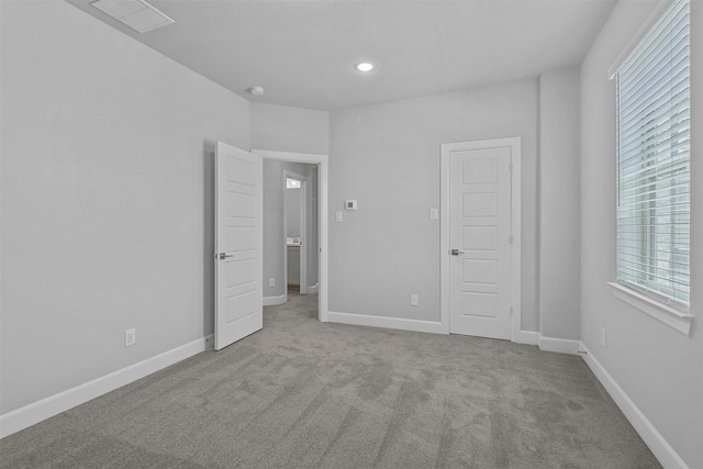 unfurnished bedroom with light carpet