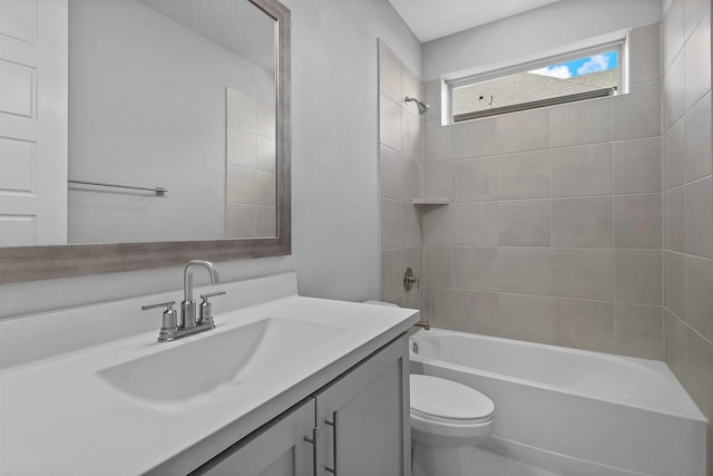 full bathroom with tiled shower / bath combo, vanity, and toilet