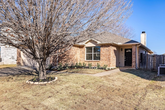 view of front of home featuring central AC unit and a front lawn