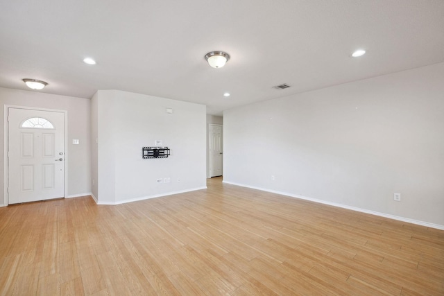 unfurnished living room featuring light wood-type flooring