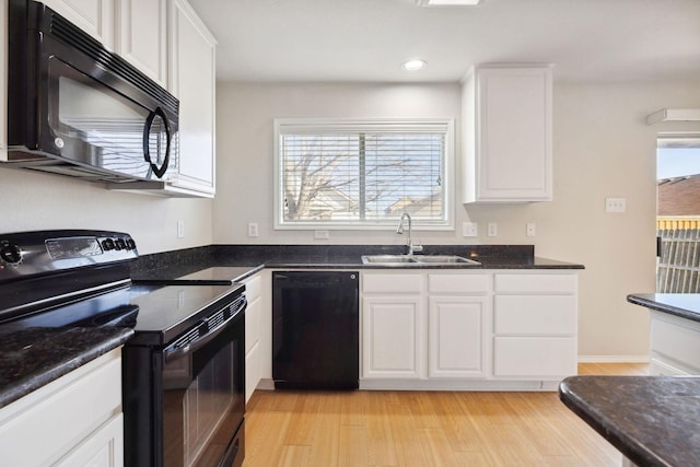 kitchen featuring white cabinets, sink, and black appliances