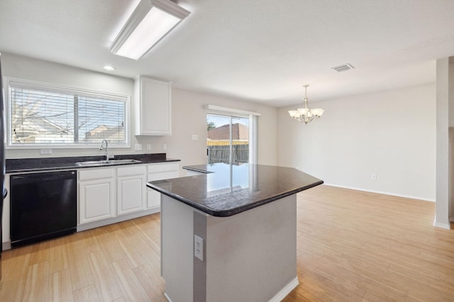 kitchen with a center island, black dishwasher, sink, and white cabinets