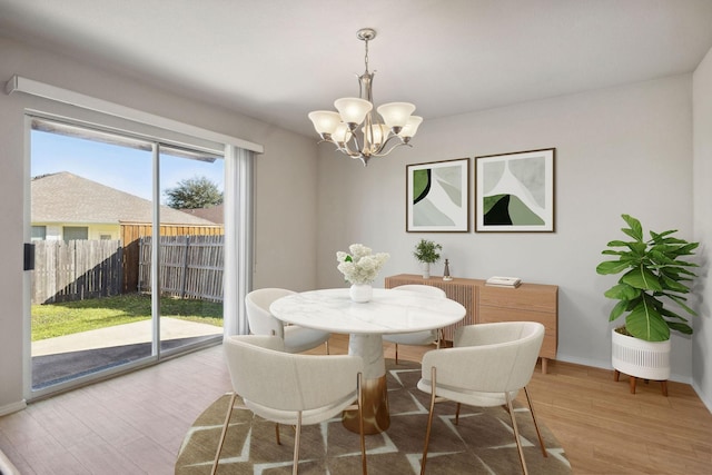 dining area featuring a chandelier and hardwood / wood-style floors