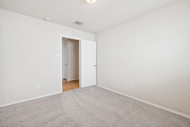 spare room with light carpet