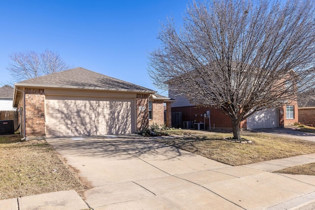 view of front of home with a garage and cooling unit