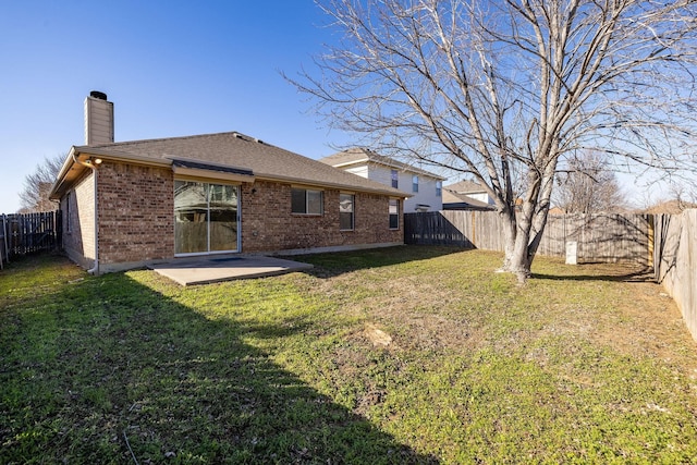 rear view of house with a patio area and a lawn