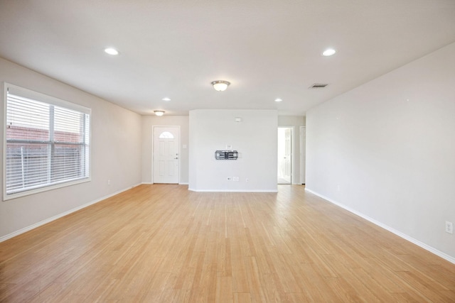 unfurnished living room featuring light wood-type flooring